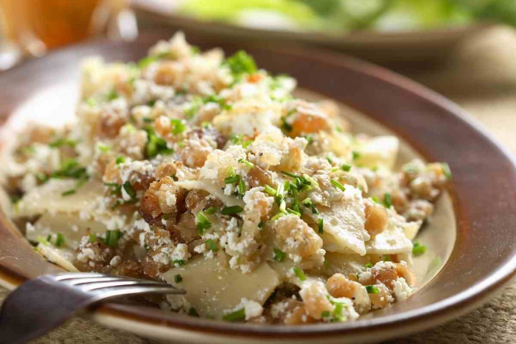 Pasta con ricotta e noci, guarnita con erba cipollina tritata