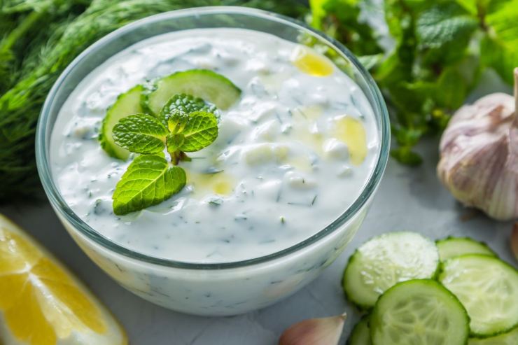 salsa tzatziki in una ciotola con ingredienti attorno