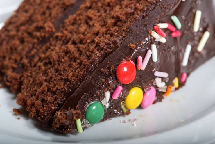 Fetta di torta al cacao con confetti colorati