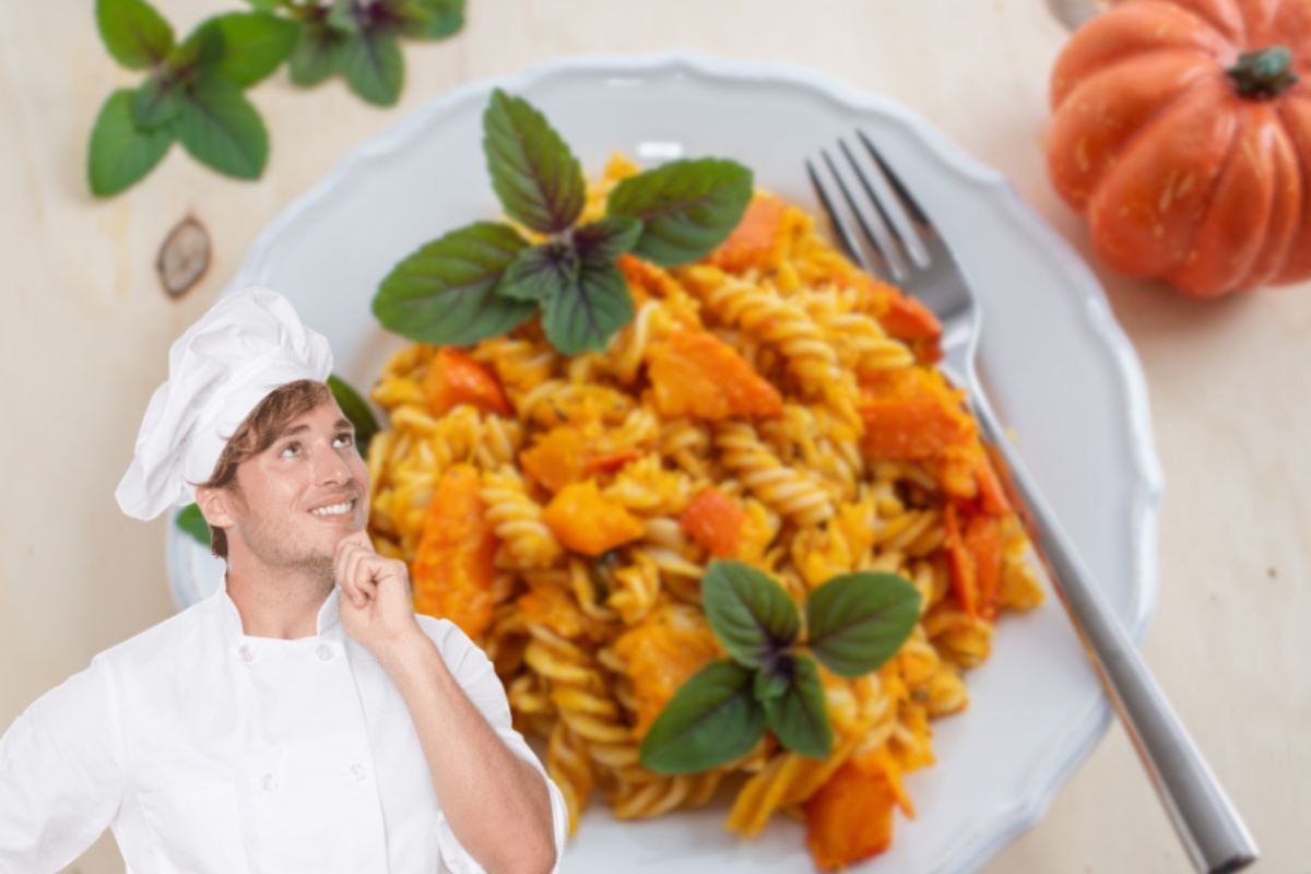 uomo vestito da chef con pasta e zucca