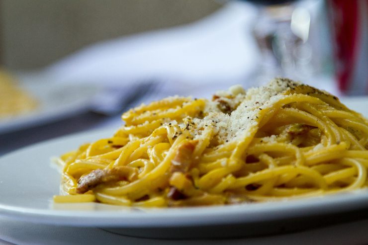 spaghetti alla carbonara con sopra il formaggio grattugiato